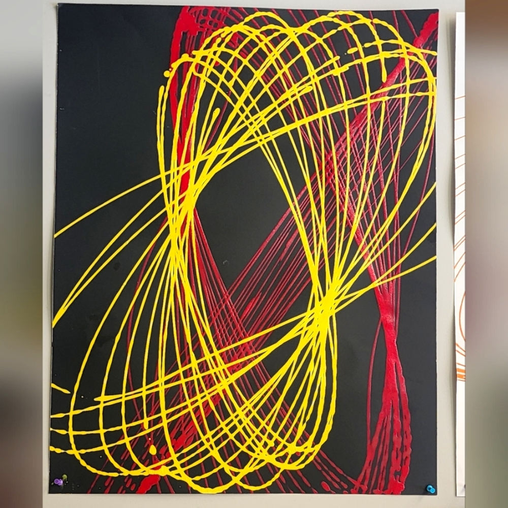 Pendulum splatter Painting  magenta and yellow on black poster board.